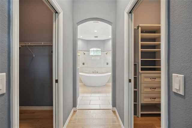 1641 Timber Hills Dr, Deland, FL 32724 - hall with arched walkways and wood finished floors