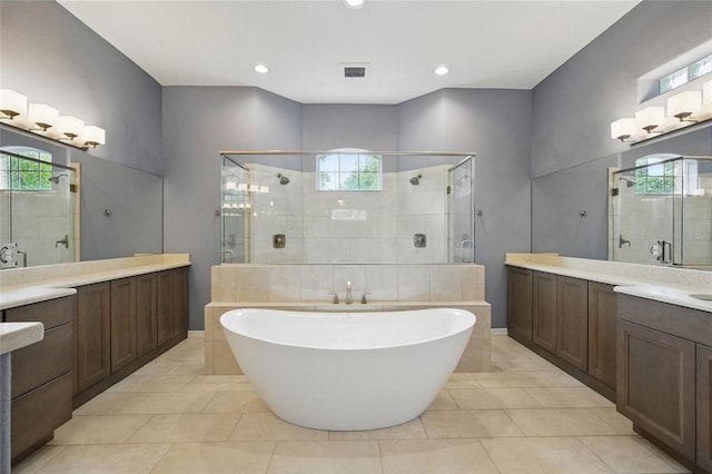 1641 Timber Hills Dr, Deland, FL 32724 - bathroom with a shower stall, tile patterned flooring, a freestanding tub, two vanities, and recessed lighting