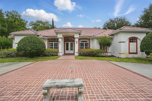 1641 Timber Hills Dr, Deland, FL 32724 - mediterranean / spanish house featuring french doors, a tile roof, and stucco siding