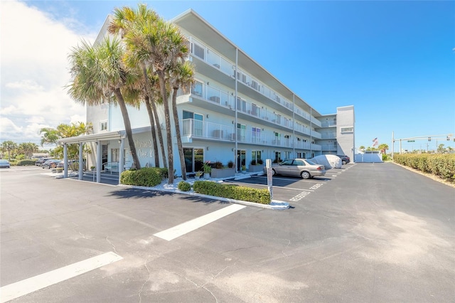 view of building exterior featuring uncovered parking