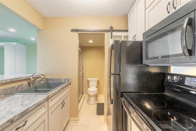 kitchen with a sink, white cabinetry, light countertops, light tile patterned floors, and electric range oven