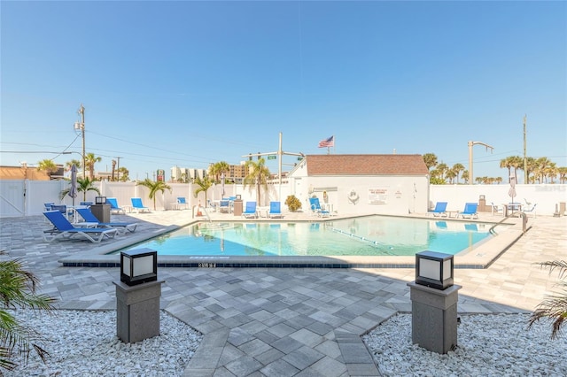 community pool featuring a patio area and fence