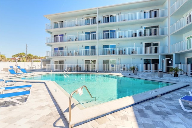 pool featuring a patio area and fence