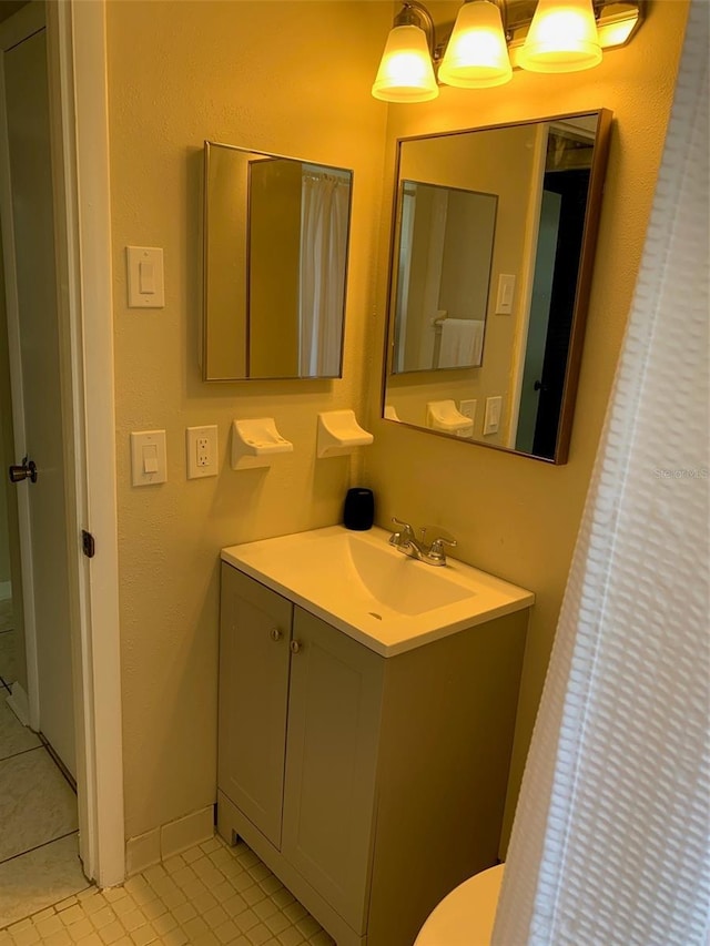 1626 S Page Dr, Deltona, FL 32725 - bathroom featuring tile patterned floors, vanity, baseboards, and toilet