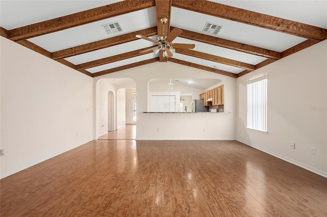 11094 SE 173rd Ln, Summerfield, FL 34491 - unfurnished living room with ceiling fan, wood finished floors, baseboards, and arched walkways
