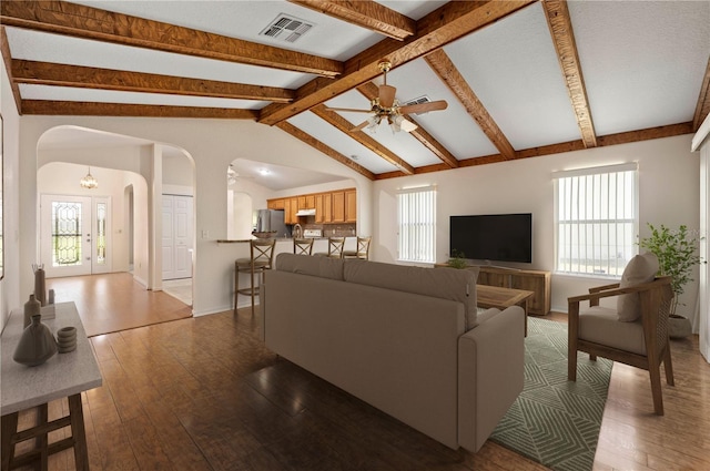11094 SE 173rd Ln, Summerfield, FL 34491 - living room with arched walkways, ceiling fan, wood-type flooring, and baseboards