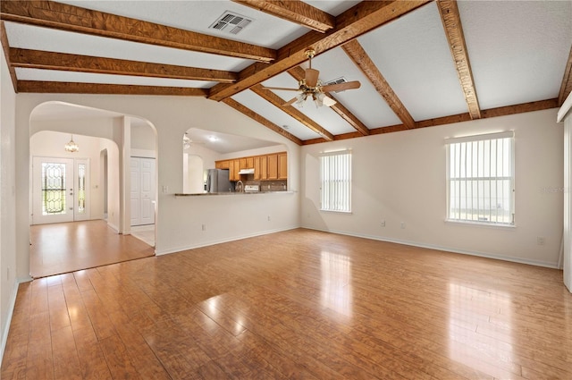 11094 SE 173rd Ln, Summerfield, FL 34491 - unfurnished living room featuring arched walkways, ceiling fan, light wood-type flooring, and baseboards