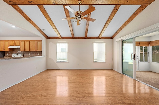 11094 SE 173rd Ln, Summerfield, FL 34491 - unfurnished living room with a ceiling fan, light wood-type flooring, a sink, and baseboards