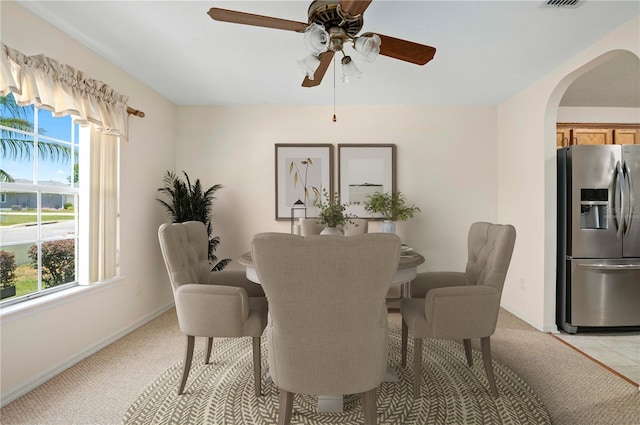 11094 SE 173rd Ln, Summerfield, FL 34491 - dining space featuring arched walkways, plenty of natural light, a ceiling fan, and baseboards