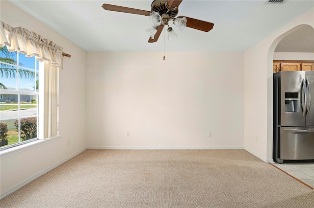 11094 SE 173rd Ln, Summerfield, FL 34491 - unfurnished room featuring healthy amount of natural light, arched walkways, a ceiling fan, and light colored carpet