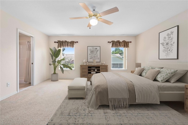11094 SE 173rd Ln, Summerfield, FL 34491 - carpeted bedroom featuring multiple windows, ceiling fan, baseboards, and connected bathroom