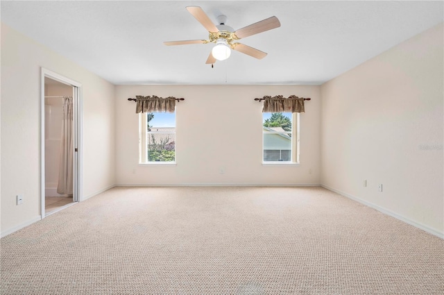 11094 SE 173rd Ln, Summerfield, FL 34491 - empty room featuring plenty of natural light, light carpet, a ceiling fan, and baseboards