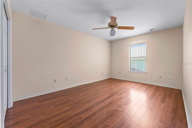 11094 SE 173rd Ln, Summerfield, FL 34491 - empty room with wood finished floors, a ceiling fan, and baseboards