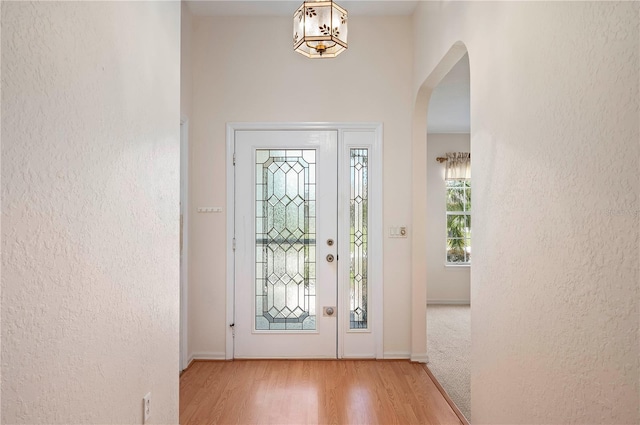 11094 SE 173rd Ln, Summerfield, FL 34491 - foyer with arched walkways, wood finished floors, baseboards, and a textured wall