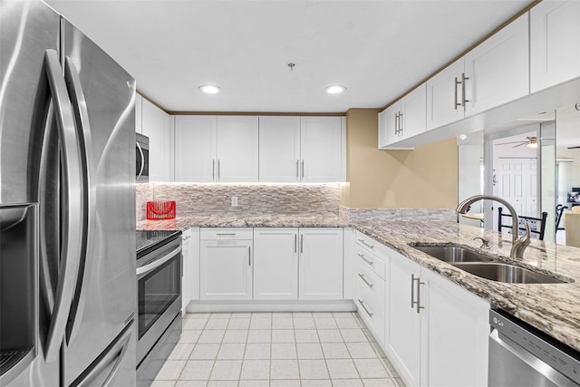 2967 S Atlantic Ave Unit 1601, Daytona Beach Shores, FL 32118 - kitchen with light tile patterned floors, ceiling fan, a sink, white cabinets, and appliances with stainless steel finishes