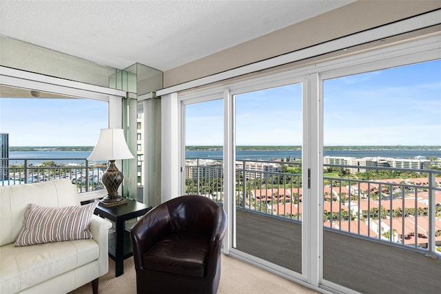 2967 S Atlantic Ave Unit 1601, Daytona Beach Shores, FL 32118 - sunroom / solarium with a water view and plenty of natural light
