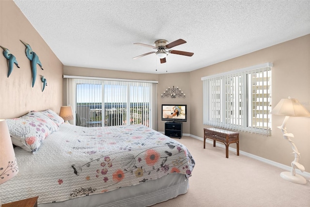 2967 S Atlantic Ave Unit 1601, Daytona Beach Shores, FL 32118 - bedroom with baseboards, carpet flooring, ceiling fan, and a textured ceiling