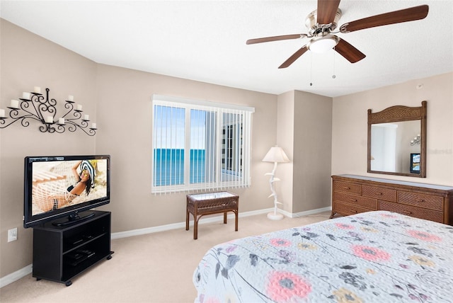 2967 S Atlantic Ave Unit 1601, Daytona Beach Shores, FL 32118 - bedroom with baseboards, light carpet, and ceiling fan