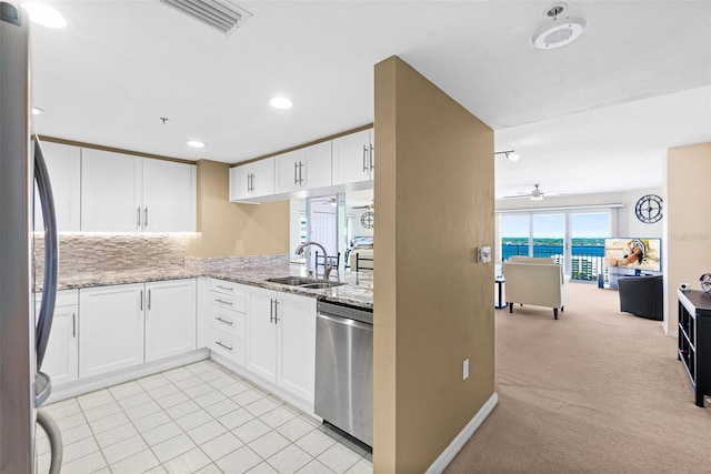 2967 S Atlantic Ave Unit 1601, Daytona Beach Shores, FL 32118 - kitchen featuring white cabinets, appliances with stainless steel finishes, a ceiling fan, and a sink