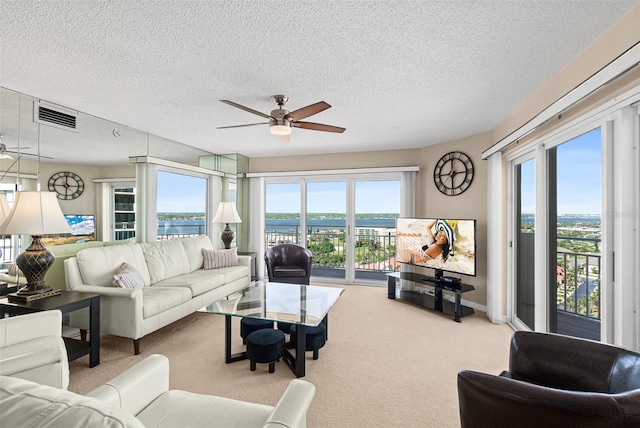 2967 S Atlantic Ave Unit 1601, Daytona Beach Shores, FL 32118 - carpeted living area featuring ceiling fan, visible vents, and a textured ceiling