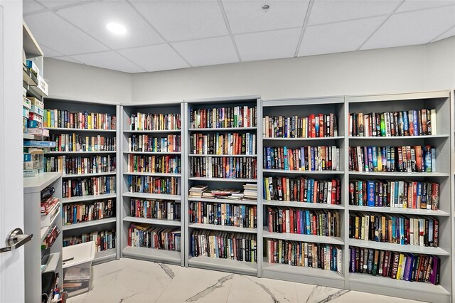 2967 S Atlantic Ave Unit 1601, Daytona Beach Shores, FL 32118 - interior space featuring bookshelves, a drop ceiling, and marble finish floor