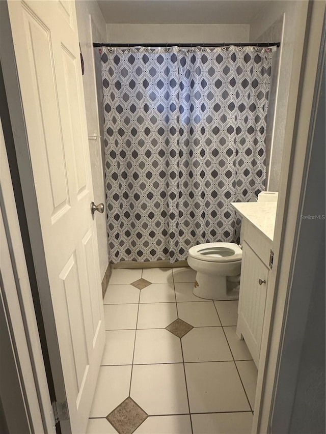 bathroom with tile patterned floors, curtained shower, toilet, and vanity