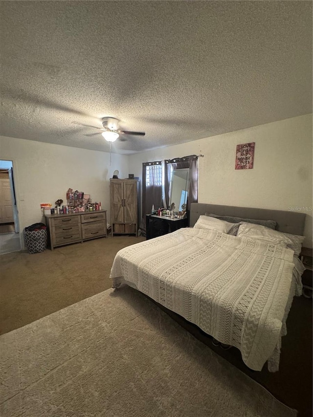 carpeted bedroom with a textured ceiling and a ceiling fan