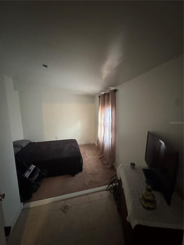 carpeted bedroom featuring baseboards
