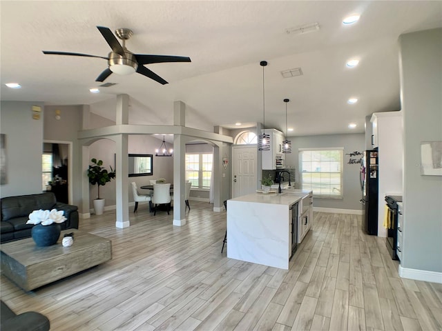 kitchen with white cabinetry, baseboards, and plenty of natural light