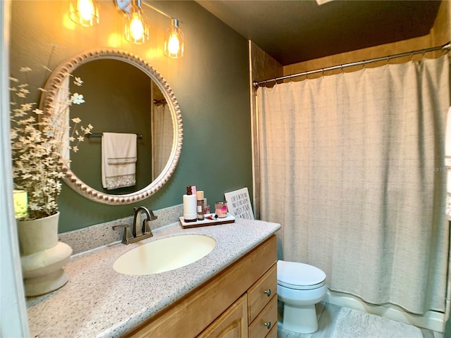 bathroom featuring toilet and vanity