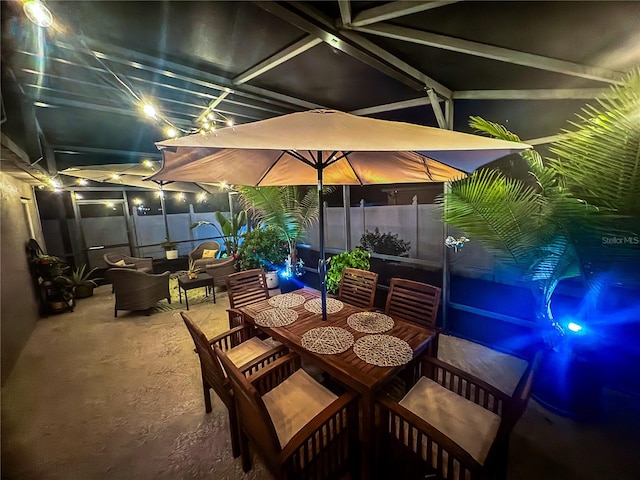 patio at twilight with an outdoor hangout area, outdoor dining space, and fence