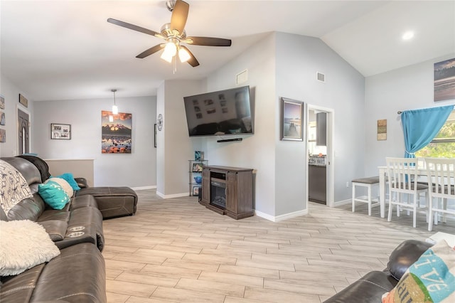85 Pheasant Dr, Palm Coast, FL 32164 - living area with baseboards, a ceiling fan, vaulted ceiling, and light wood-type flooring