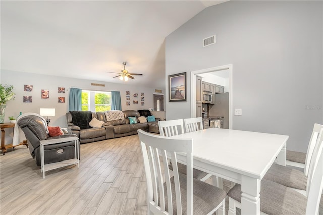 85 Pheasant Dr, Palm Coast, FL 32164 - dining area with ceiling fan, vaulted ceiling, and light wood-style flooring