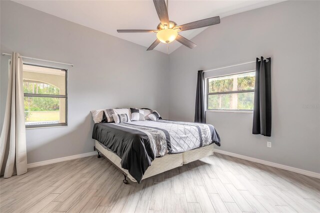 85 Pheasant Dr, Palm Coast, FL 32164 - bedroom with multiple windows, vaulted ceiling, wood finished floors, baseboards, and ceiling fan