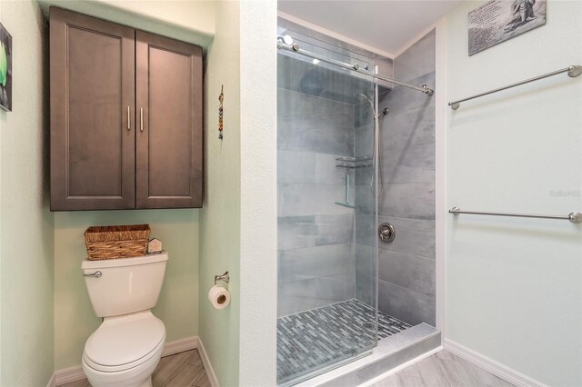 85 Pheasant Dr, Palm Coast, FL 32164 - bathroom with a stall shower, toilet, and baseboards