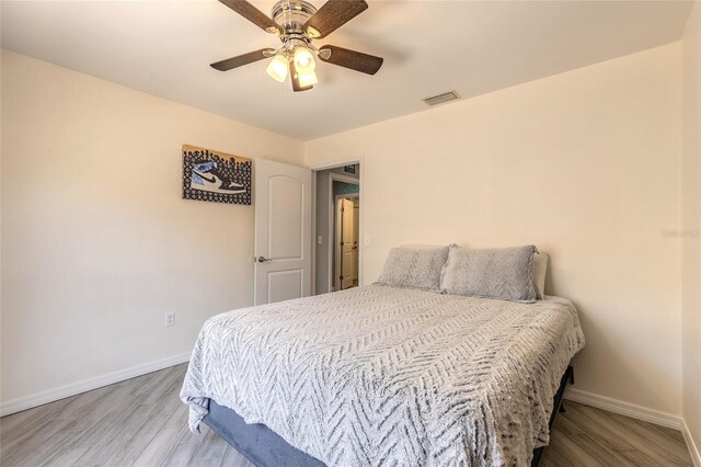 85 Pheasant Dr, Palm Coast, FL 32164 - bedroom featuring baseboards, wood finished floors, and ceiling fan