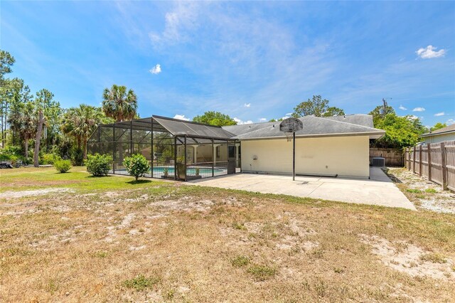 85 Pheasant Dr, Palm Coast, FL 32164 - rear view of house with an outdoor pool, a patio, cooling unit, and glass enclosure