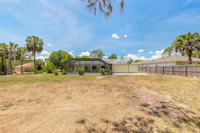85 Pheasant Dr, Palm Coast, FL 32164 - view of yard featuring a lanai, a patio, an attached garage, and a pool