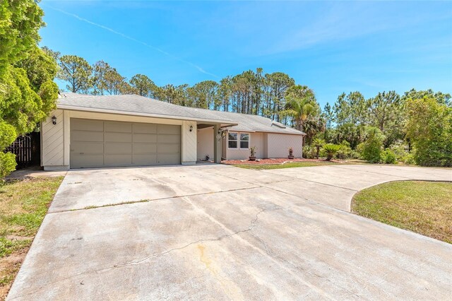 85 Pheasant Dr, Palm Coast, FL 32164 - ranch-style house featuring driveway and an attached garage