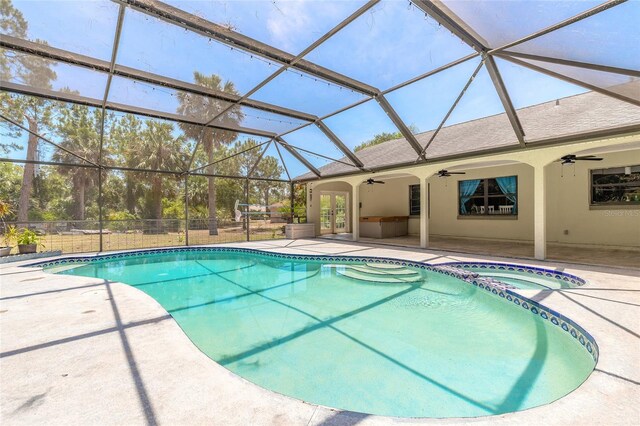 85 Pheasant Dr, Palm Coast, FL 32164 - view of swimming pool with ceiling fan, a patio, a pool with connected hot tub, and french doors