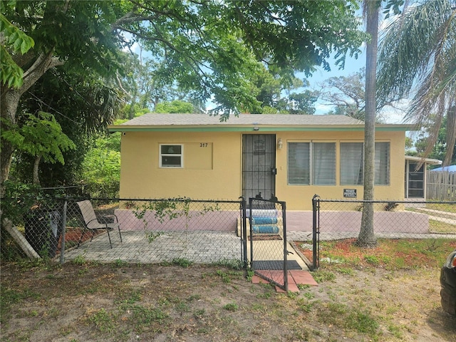 317 Inwood Ave, New Smyrna Beach, FL 32168 - view of front of property with stucco siding and a gate