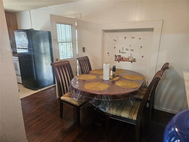 317 Inwood Ave, New Smyrna Beach, FL 32168 - dining space with hardwood / wood-style floors and wooden walls