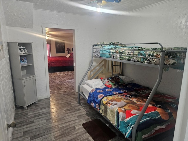 317 Inwood Ave, New Smyrna Beach, FL 32168 - bedroom with a textured wall and wood finished floors