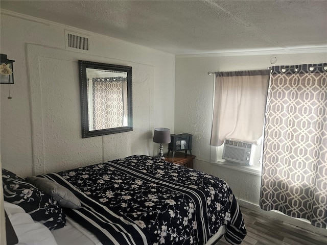 317 Inwood Ave, New Smyrna Beach, FL 32168 - bedroom with wood finished floors, a textured ceiling, cooling unit, crown molding, and baseboards
