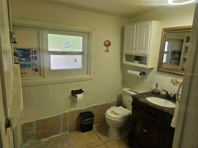 317 Inwood Ave, New Smyrna Beach, FL 32168 - half bathroom featuring tile patterned floors, toilet, a textured ceiling, a textured wall, and vanity