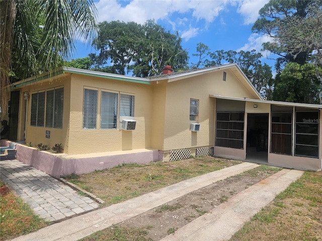 317 Inwood Ave, New Smyrna Beach, FL 32168 - view of property exterior featuring stucco siding and a sunroom