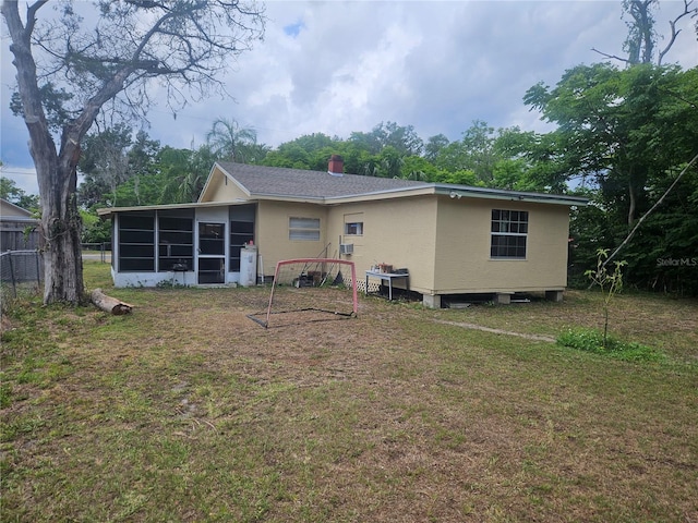 317 Inwood Ave, New Smyrna Beach, FL 32168 - back of property featuring a sunroom