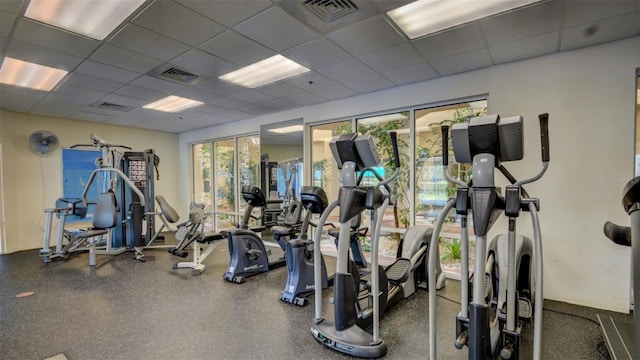 workout area featuring visible vents and a drop ceiling