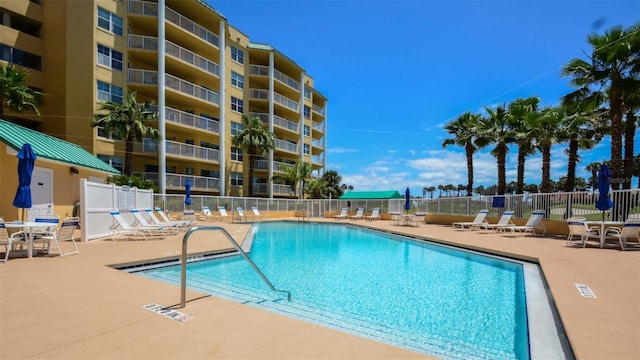 community pool featuring fence and a patio