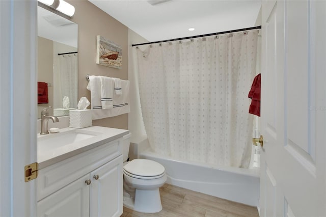full bathroom with vanity, shower / bath combo, toilet, and wood finished floors